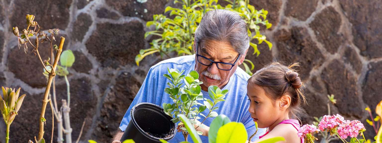 grandfather and granddaughter gardening