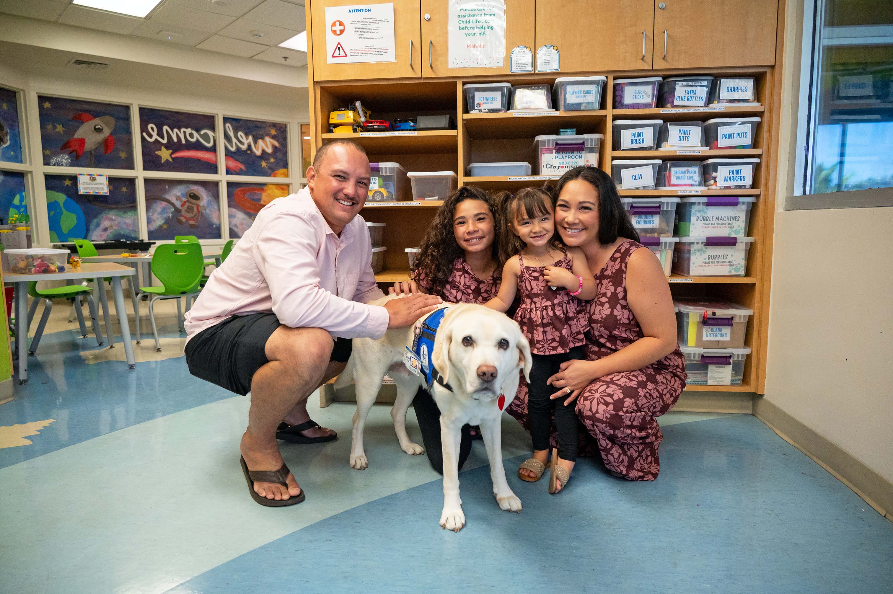 The Borges ʻOhana with a therapy dog at the Kapiʻolani Medical Center for Women and Children