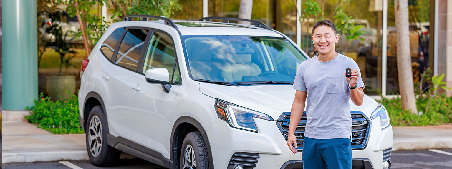member standing in front of vehicle holding key fob